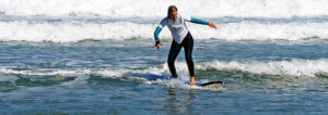 surfer girl rides a wave on the surf course in Praia Azul - Santa Cruz